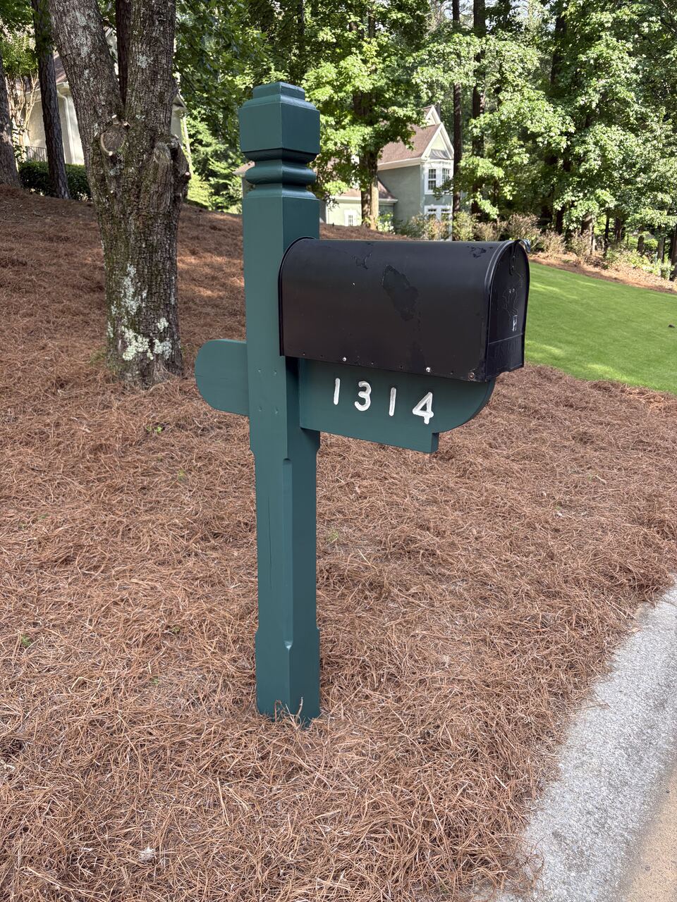 Mailbox bed freshened with pine straw